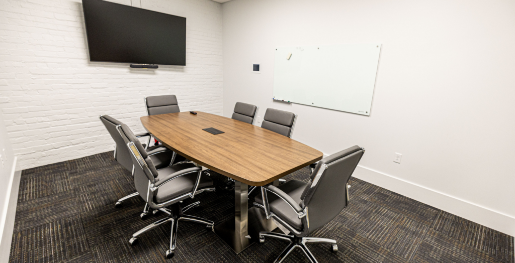 A tidy office featuring a desk with a computer, showcasing a professional and organized workspace.
