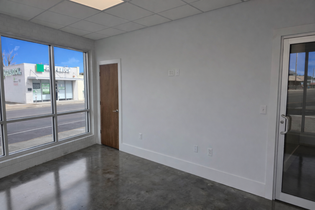 An office featuring a desk, a chair, and a window
